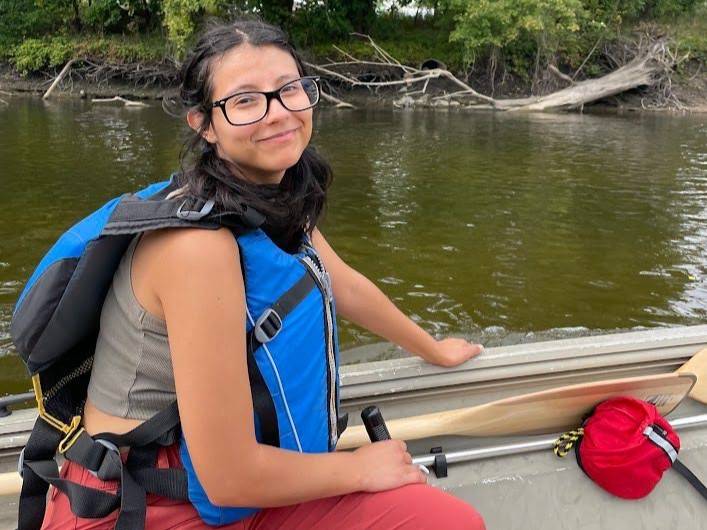 Paris Velasquez conducts fieldwork on a lake.